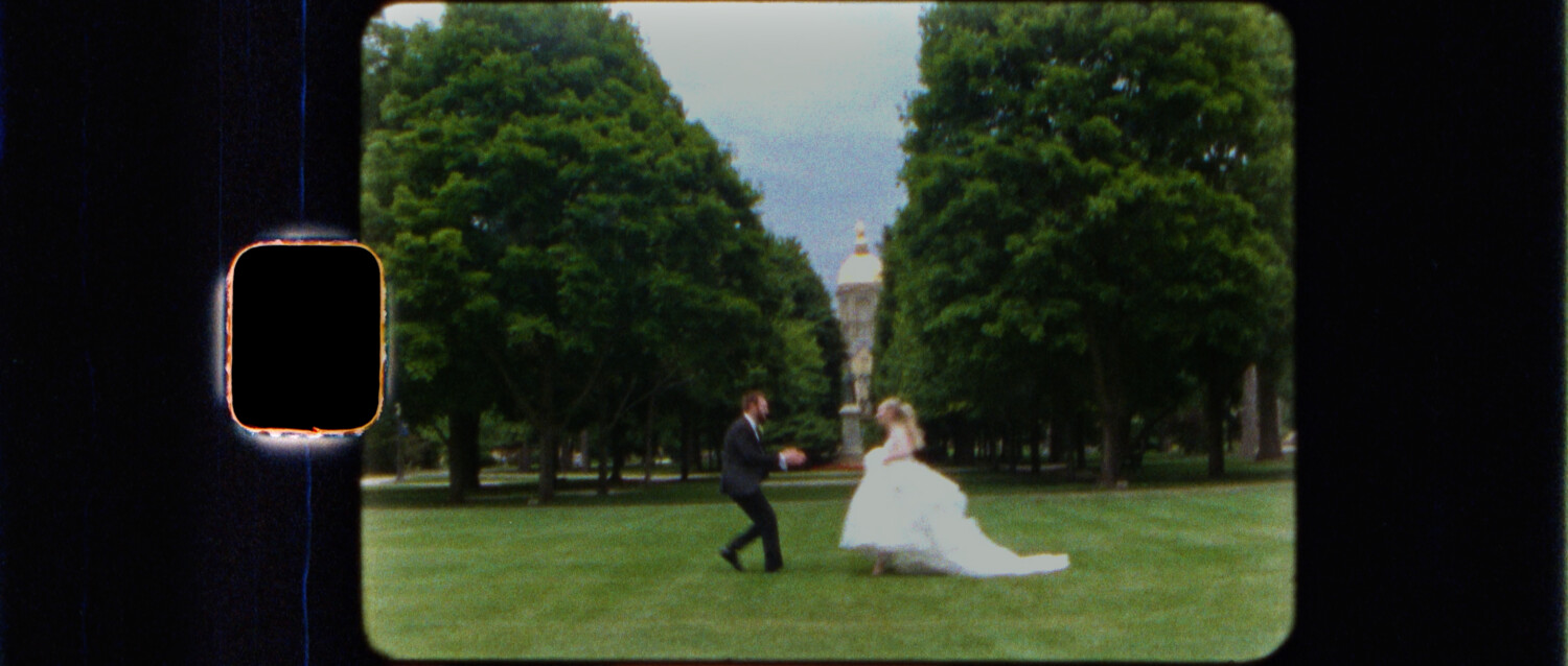 bride and groom hugging with the golden dome in the background at notre dame campus