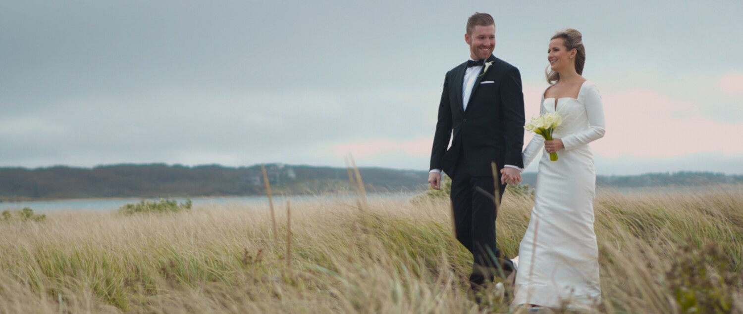 bride and groom walking on beach at the wauwinet nantucket